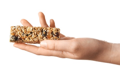 Woman holding grain cereal bar on white background. Healthy snack