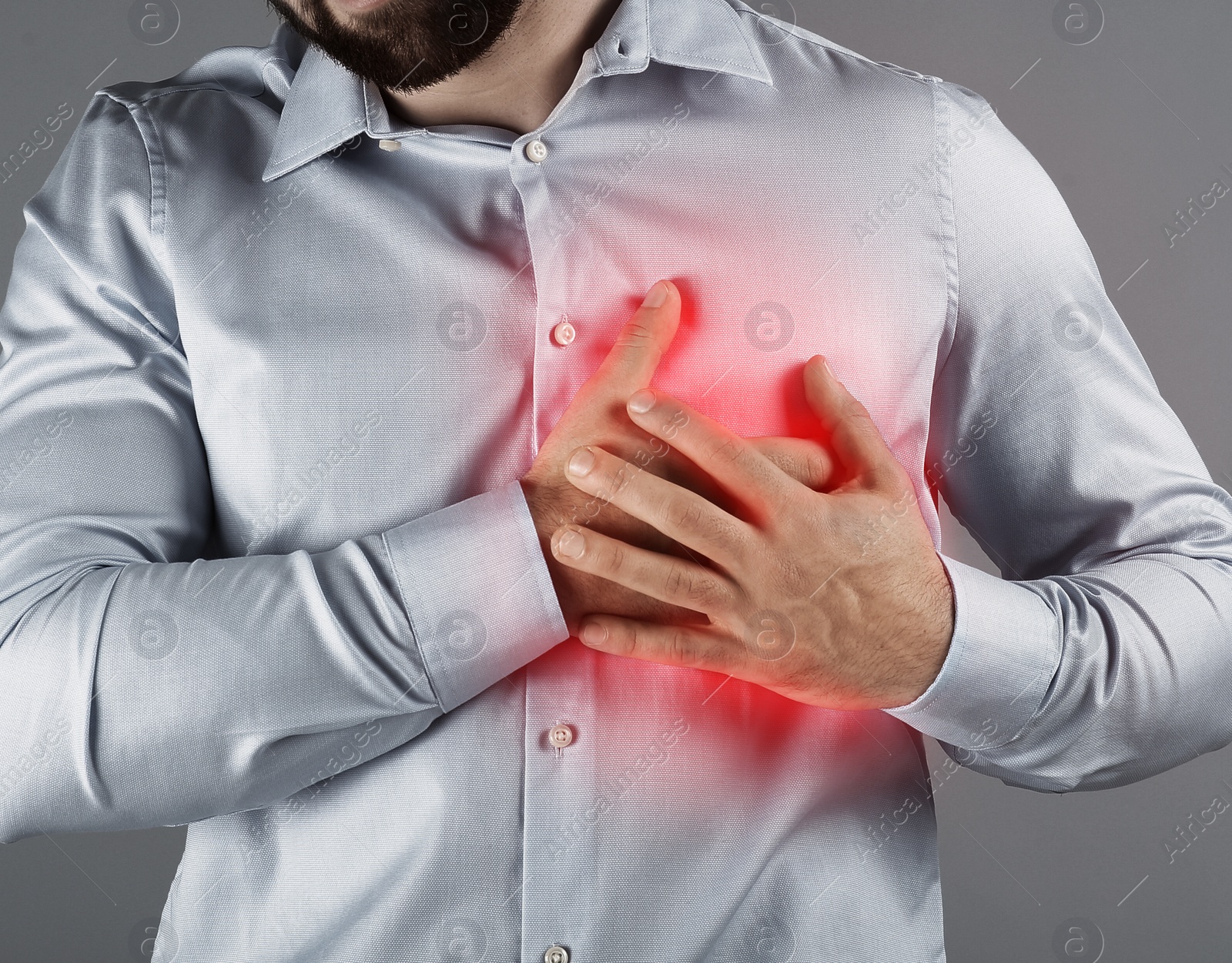 Image of Man having heart attack on light grey background, closeup