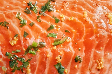 Photo of Raw salmon fillet with marinade as background, closeup
