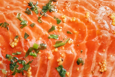 Raw salmon fillet with marinade as background, closeup