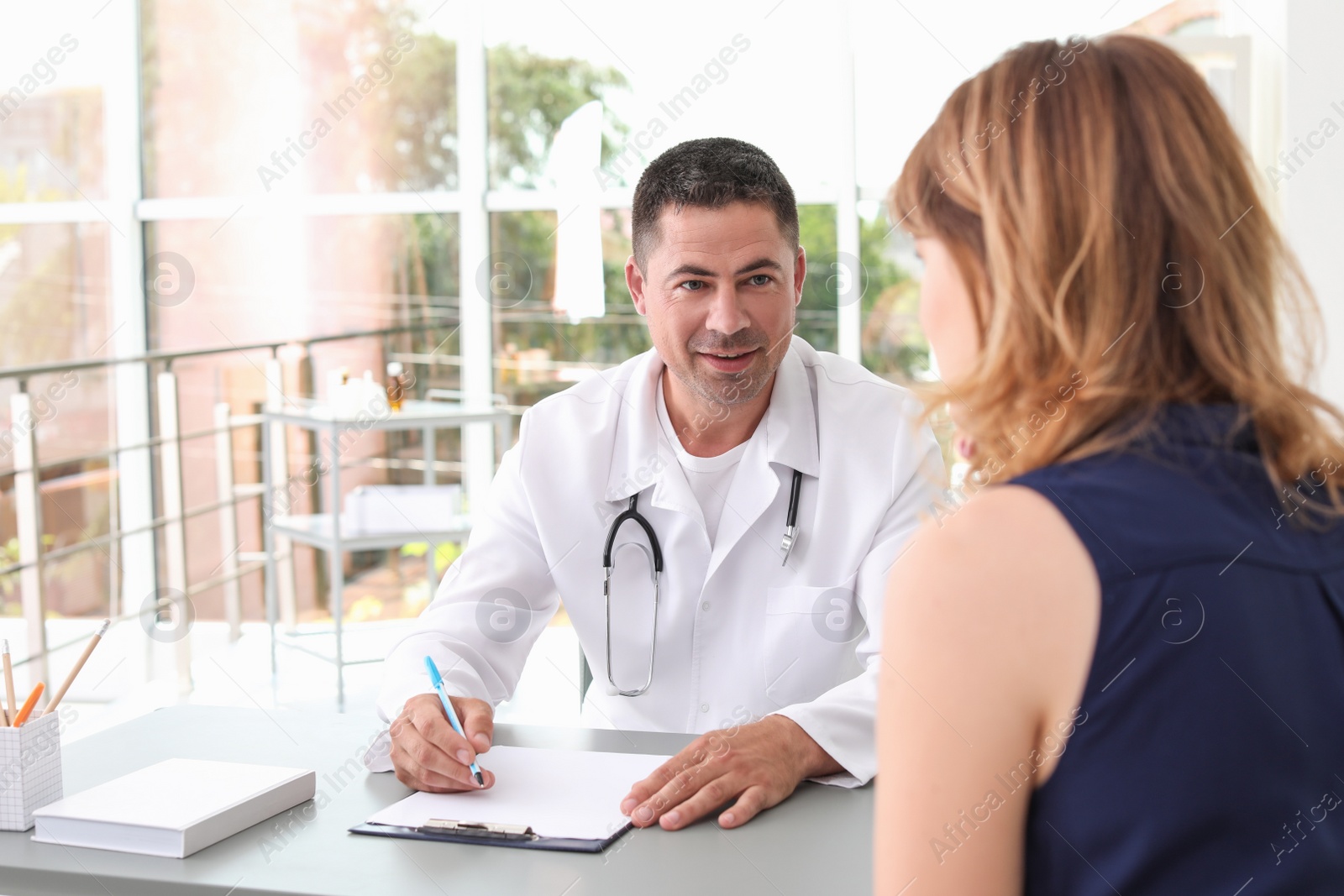 Photo of Patient having appointment with doctor in hospital