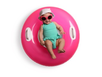 Photo of Cute little baby in sunglasses with inflatable ring on white background, top view