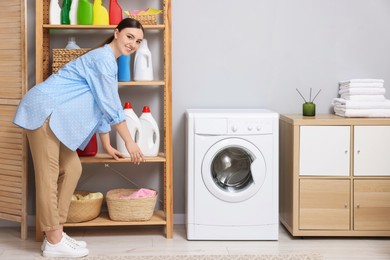 Beautiful woman in laundry room with washing machine