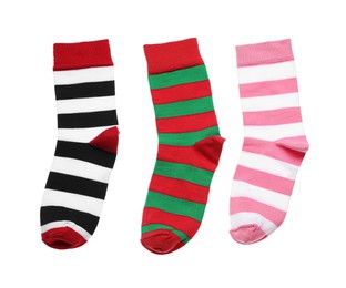 Photo of Different striped socks on white background, top view