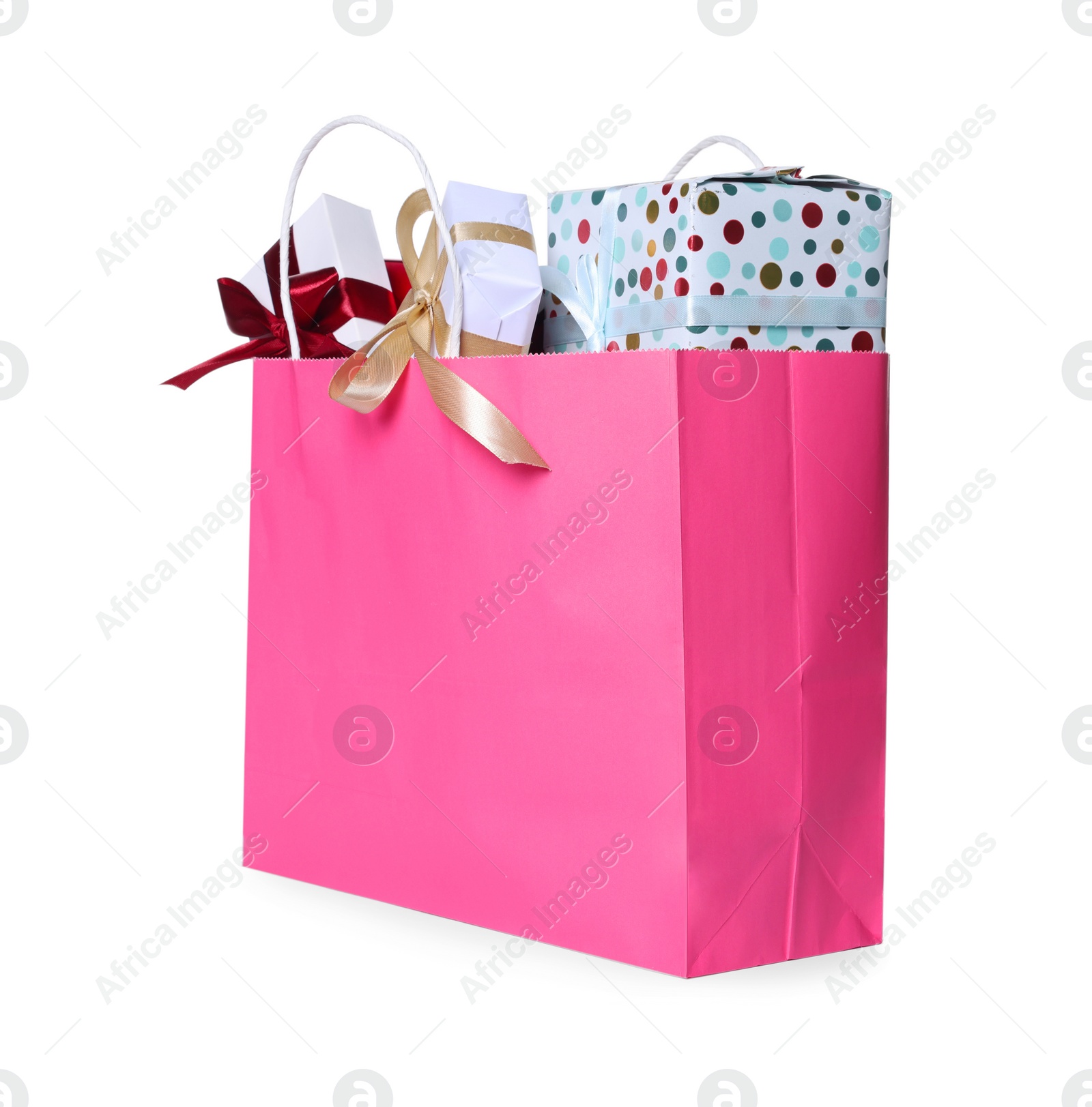 Photo of Pink paper shopping bag full of gift boxes on white background