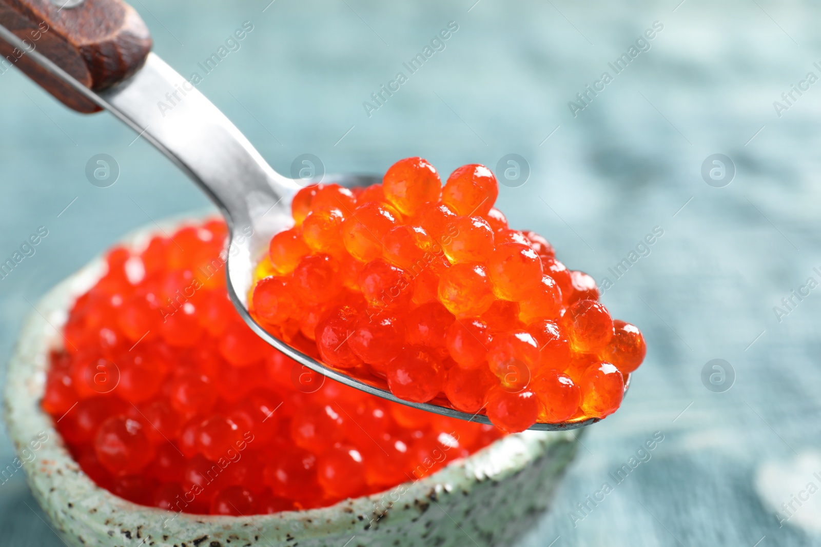 Photo of Spoon with delicious red caviar, closeup