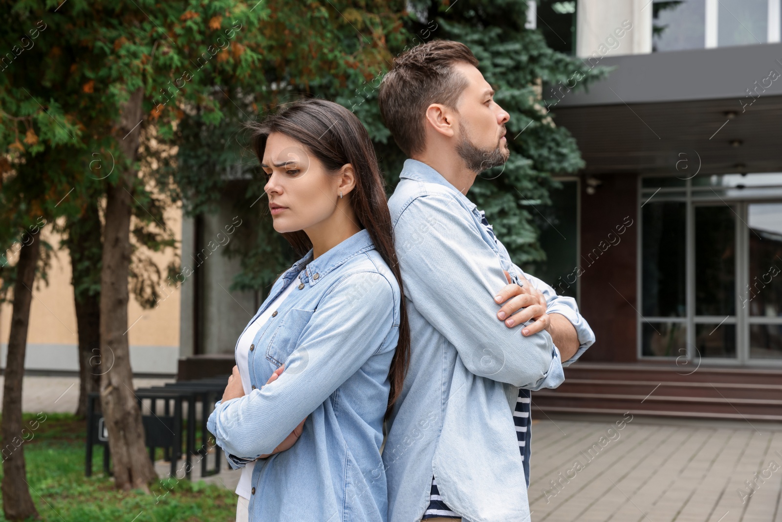 Photo of Upset arguing couple in park. Relationship problems