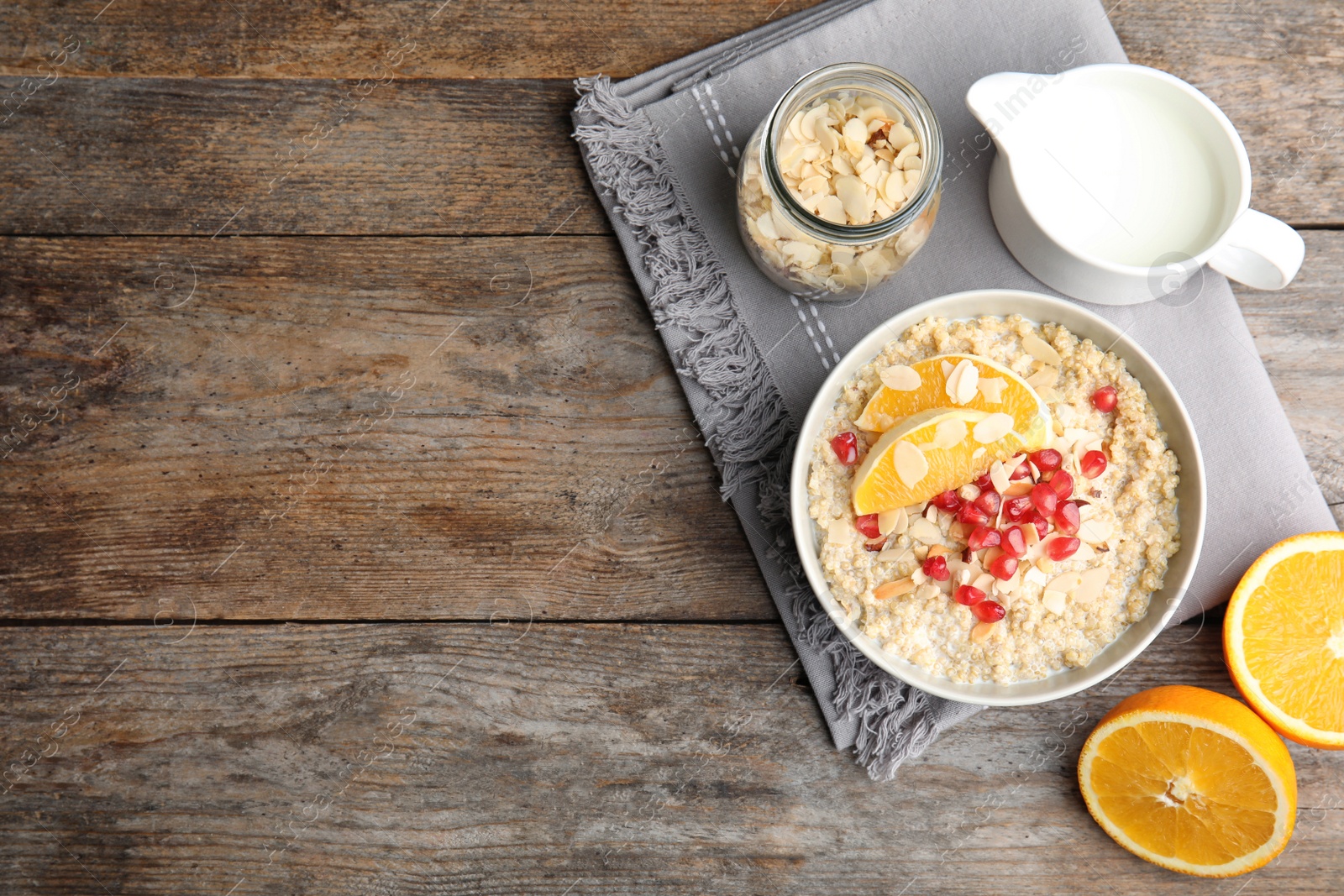 Photo of Flat lay composition with quinoa porridge, cream and space for text on wooden background