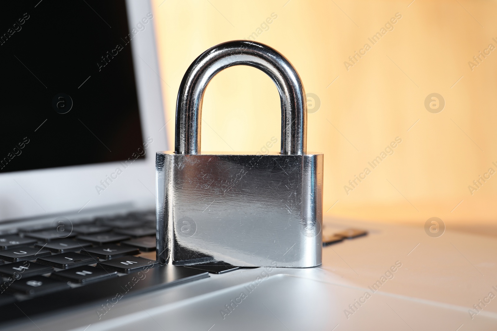 Photo of Cyber security. Padlock on laptop, closeup view