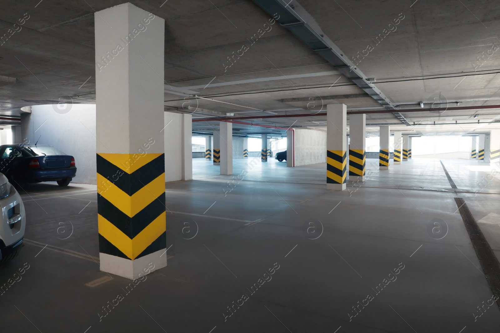 Photo of Open parking garage with cars on sunny day