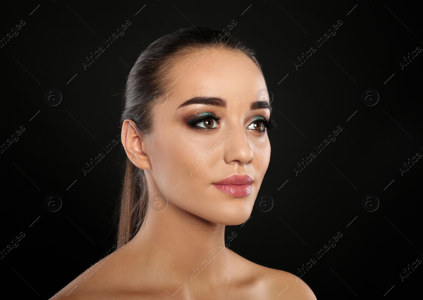 Photo of Portrait of young woman with eyelash extensions and beautiful makeup on black background