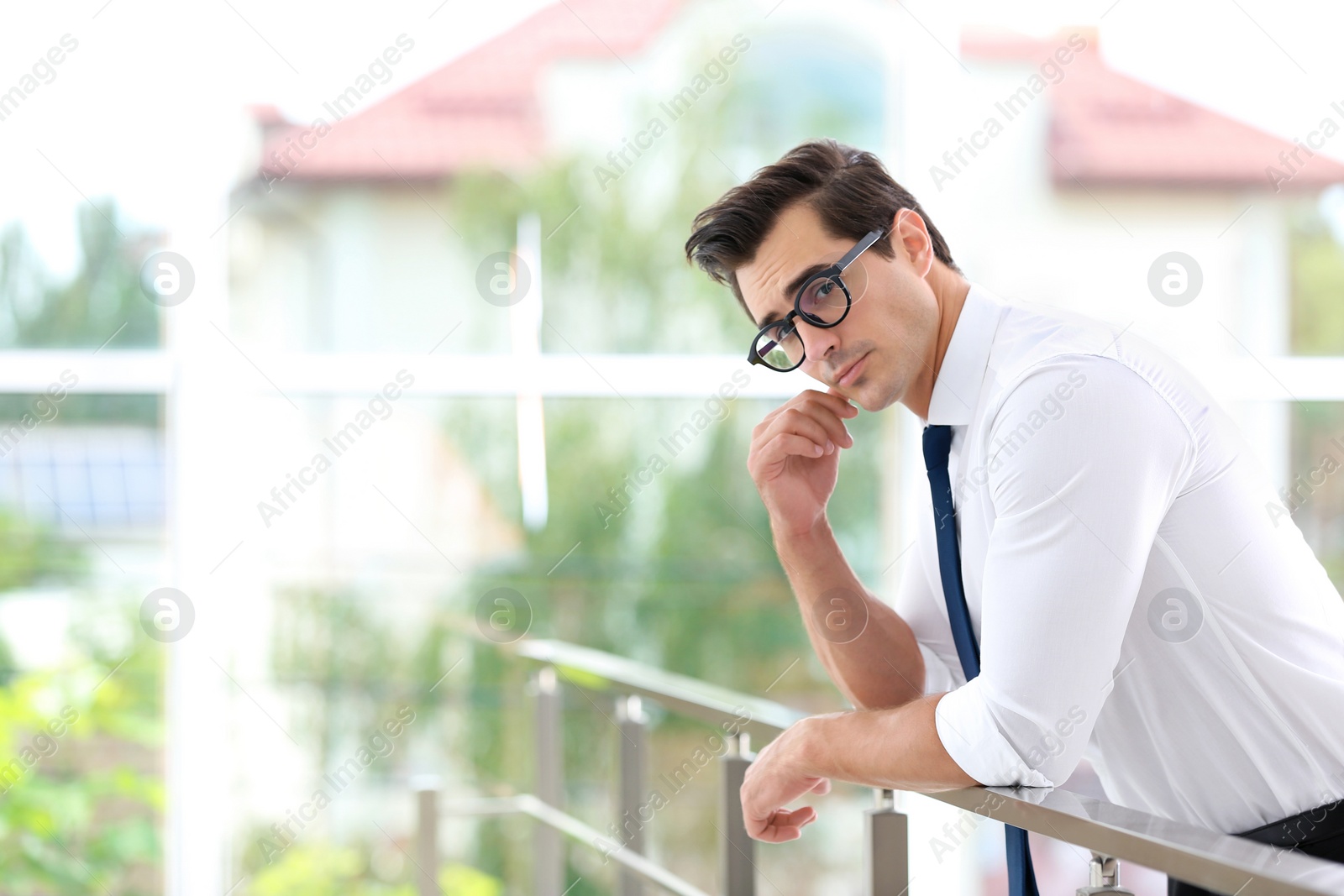 Photo of Handsome young man in stylish clothes with glasses indoors. Space for text