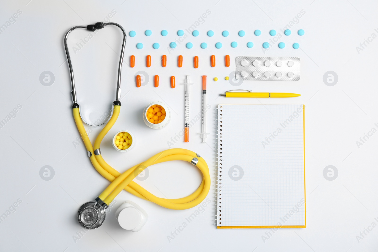 Photo of Flat lay composition with medical equipment and pills on light background