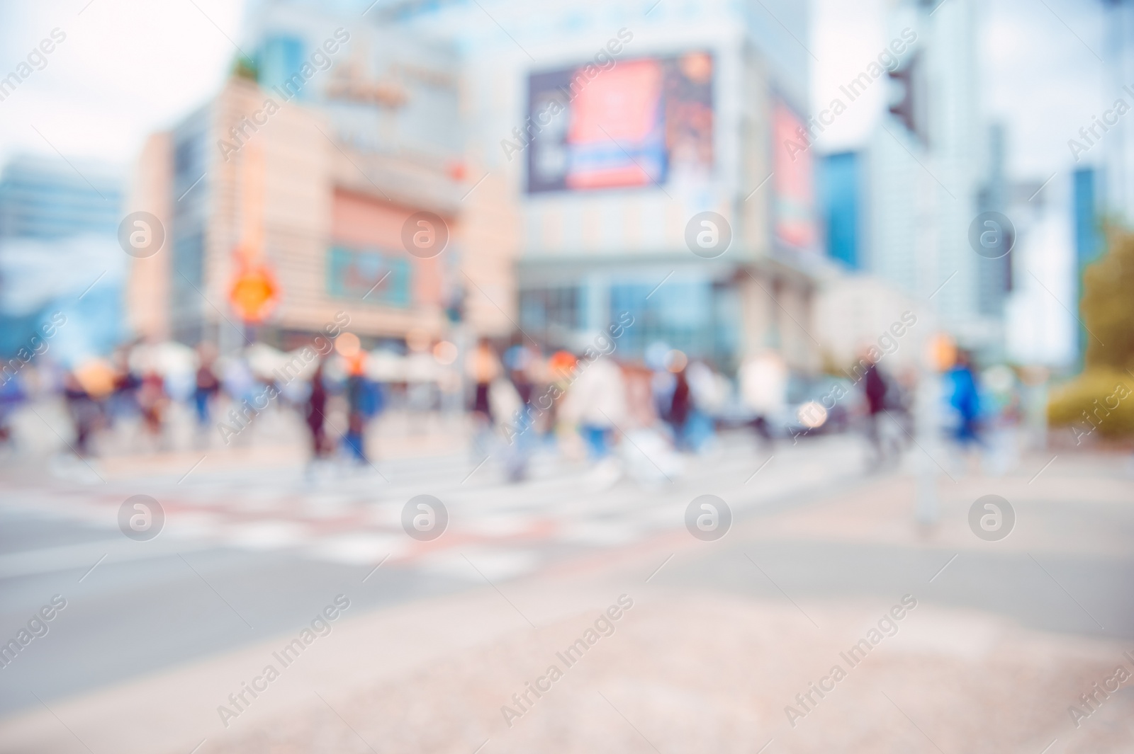 Photo of People crossing street in city, blurred view