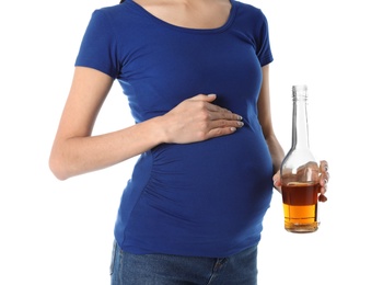 Photo of Future mother with bottle of alcohol drink on white background, closeup. Bad habits during pregnancy