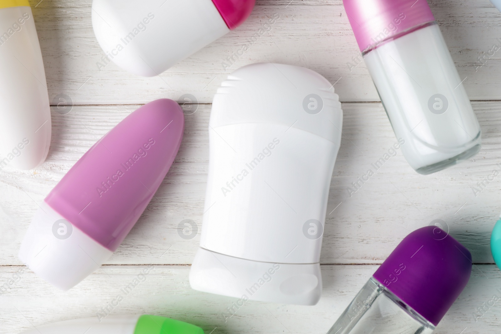 Photo of Flat lay composition with different deodorants on white wooden table