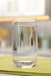 Photo of Glass with clear water on table in kitchen