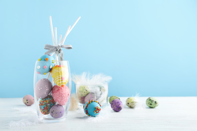 Photo of Delicious sweet cake pops on white wooden table , space for text. Easter holiday