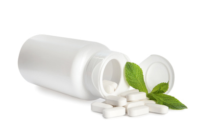 Bottle with vitamin pills and mint on white background