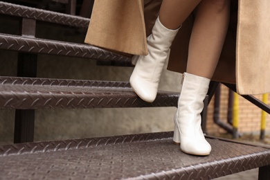 Woman wearing stylish leather shoes on stairs outdoors, closeup