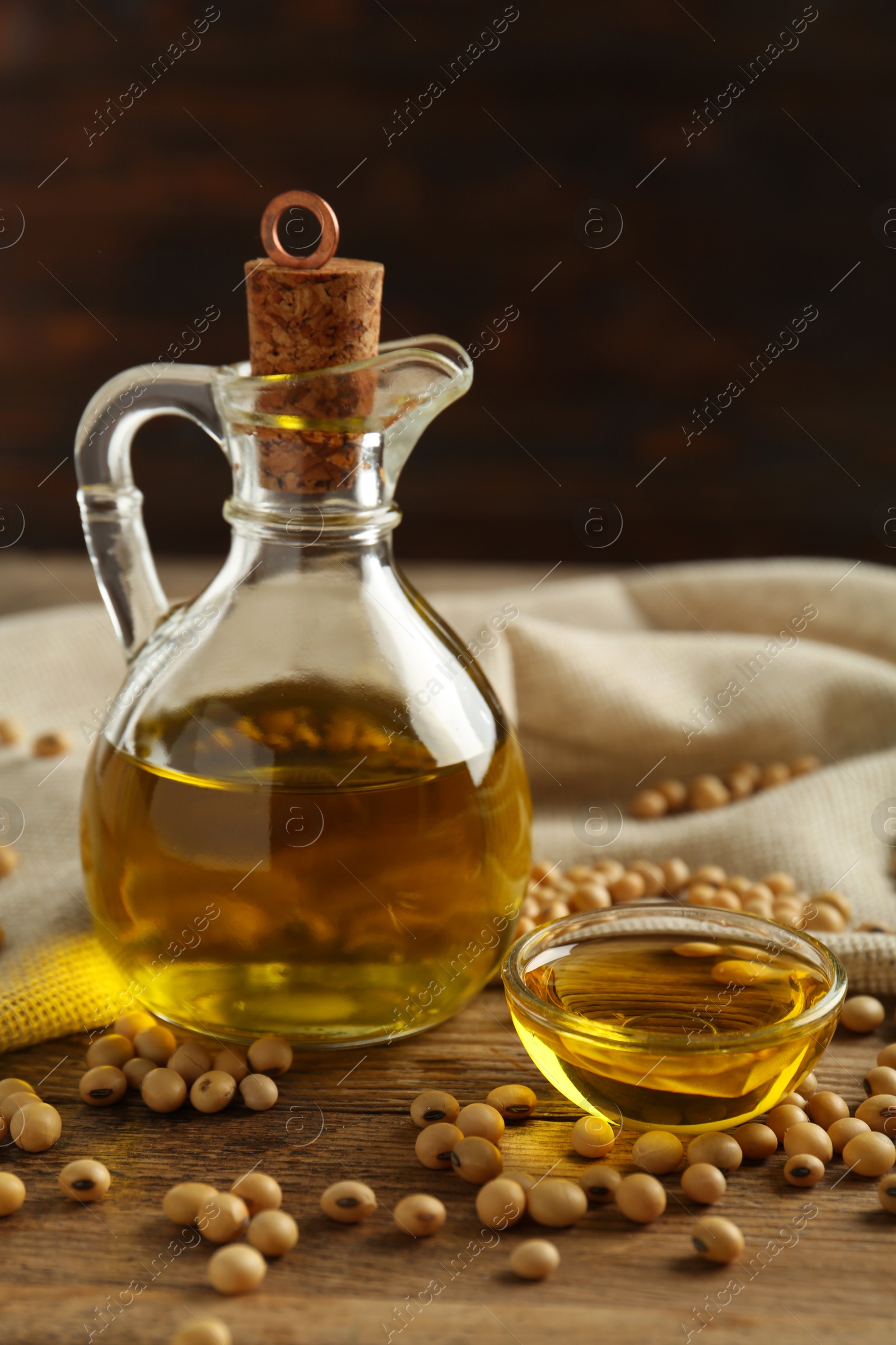 Photo of Composition with soybean oil on wooden table