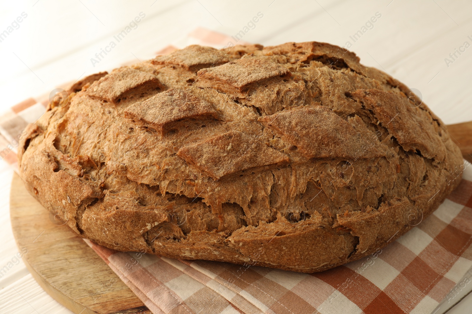 Photo of Freshly baked sourdough bread on white table