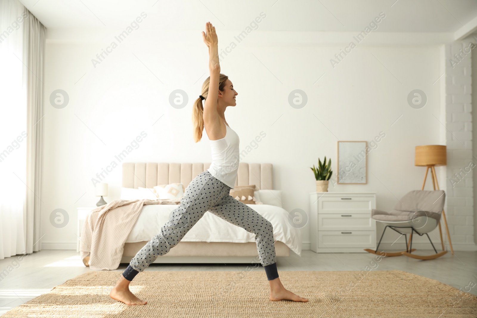 Photo of Young woman doing exercises at home. Morning fitness