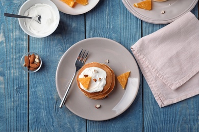 Photo of Flat lay composition with tasty pancakes on wooden background