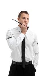 Male security guard using portable radio transmitter on white background