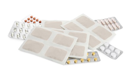Mustard plasters and pills on white background