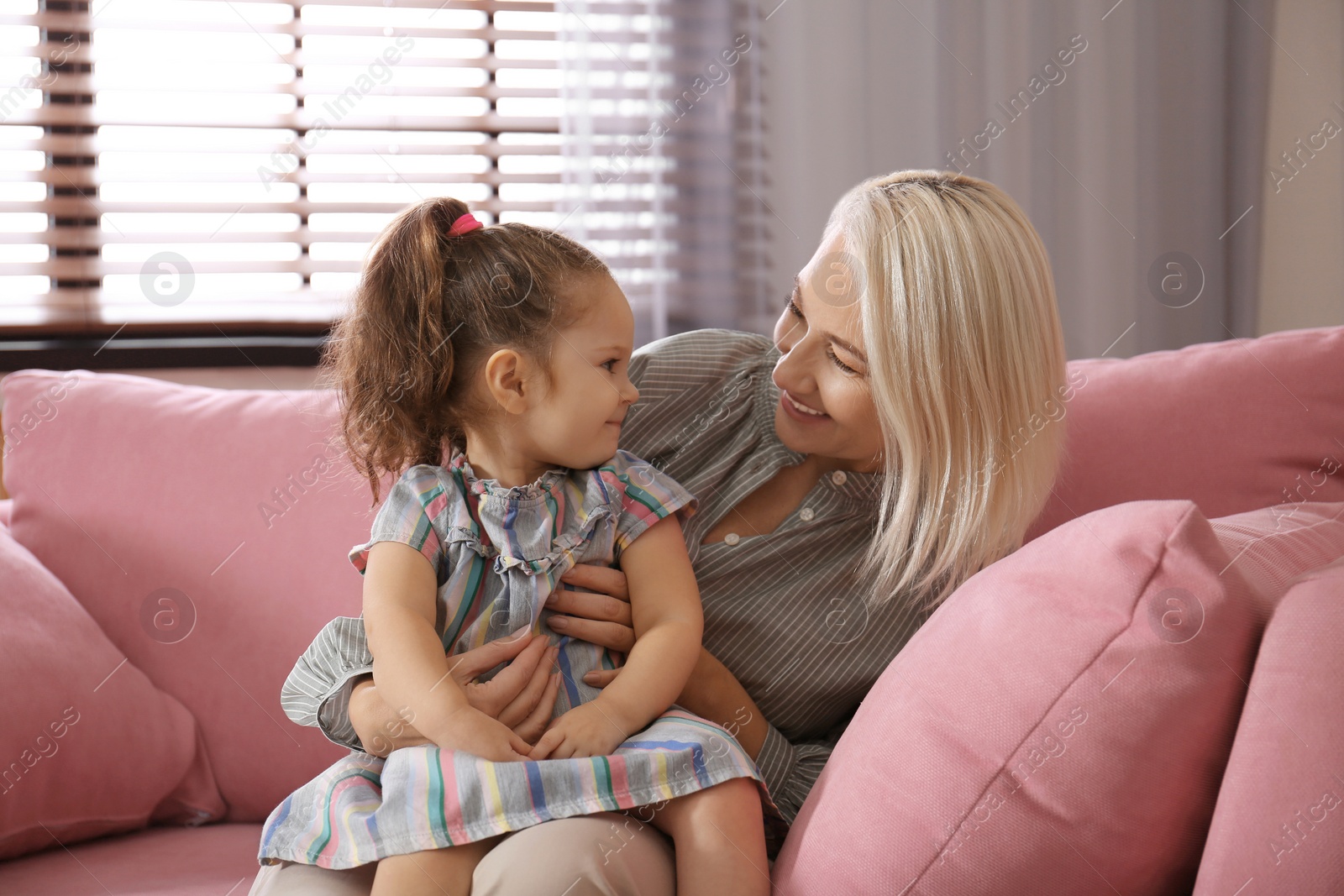 Photo of Happy granddaughter and grandmother together at home