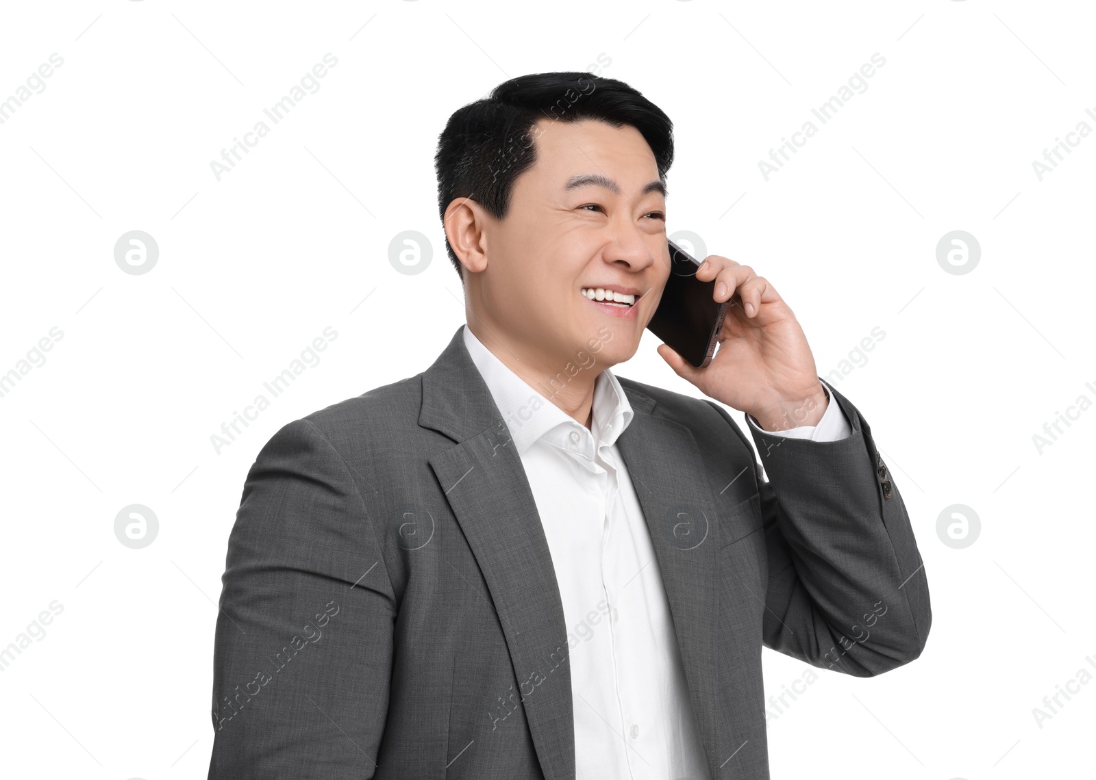 Photo of Businessman in suit talking on phone against white background