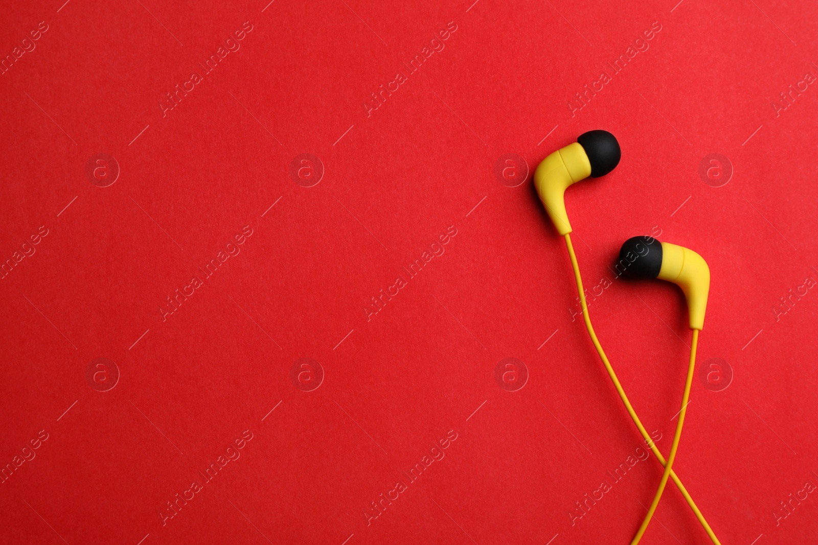 Photo of Stylish headphones on color background, top view. Space for text