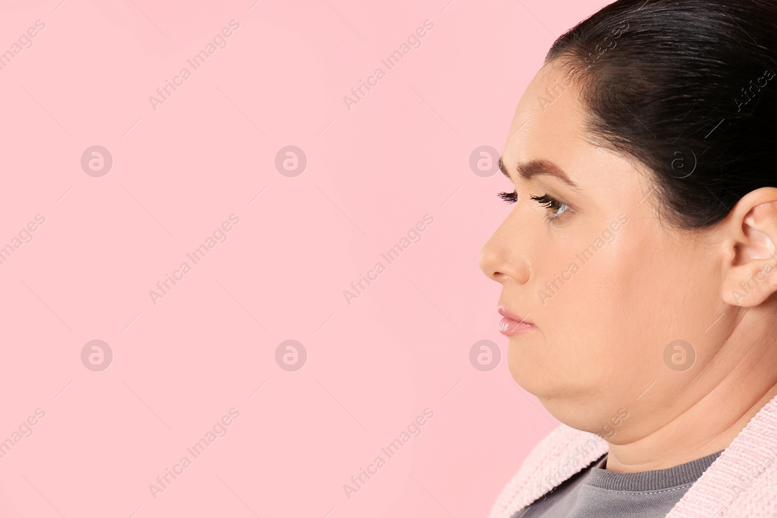 Photo of Woman with double chin on pink background. Space for text