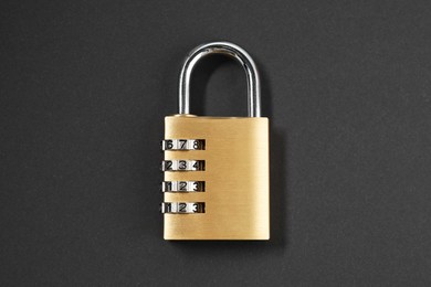 Photo of One steel combination padlock on black background, top view