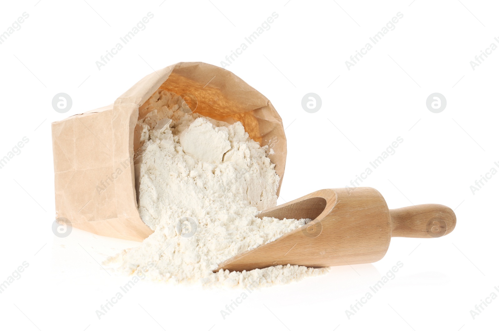 Photo of Paper bag and scoop with flour isolated on white