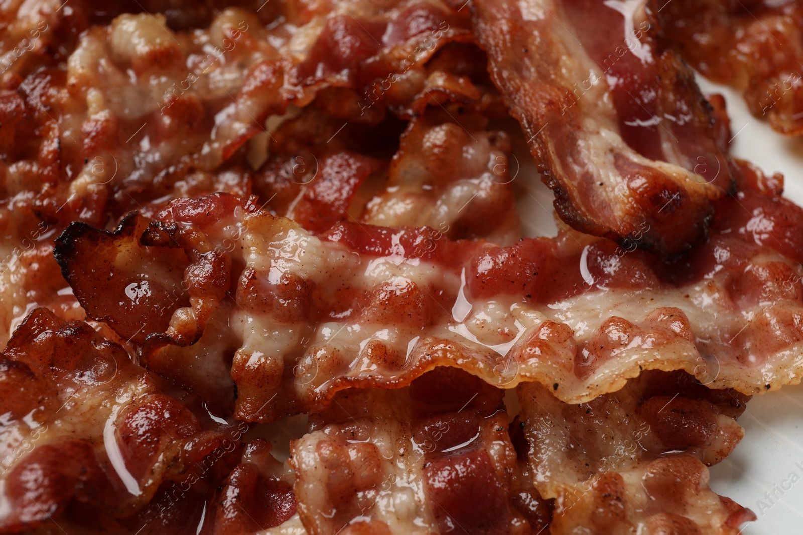 Photo of Slices of tasty fried bacon as background, closeup