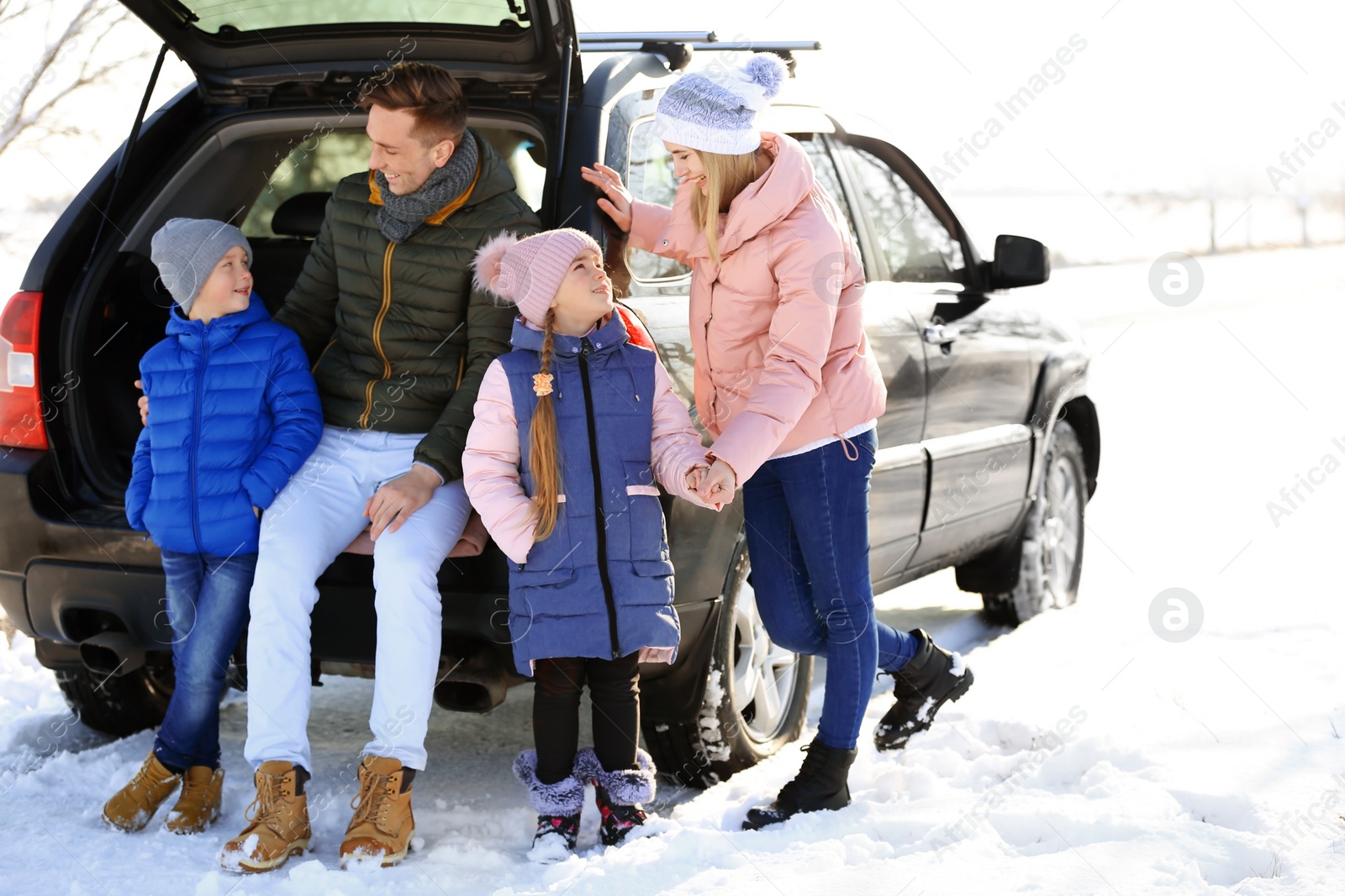 Photo of Happy family near car on winter day