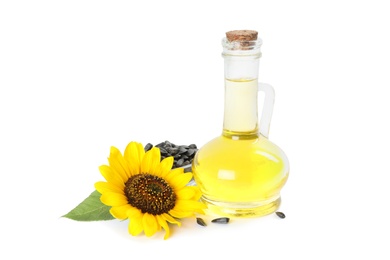 Photo of Sunflower, jug of oil and seeds on white background