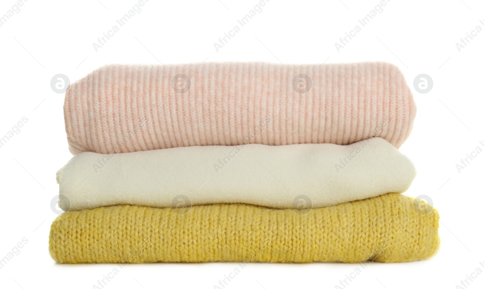 Photo of Stack of different warm sweaters isolated on white