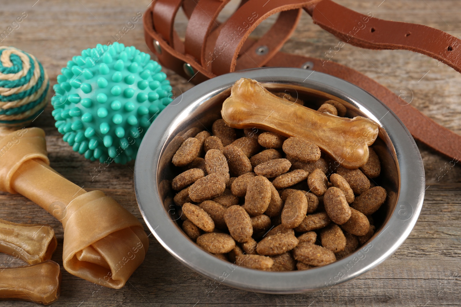 Photo of Different pet goods on wooden table, closeup. Shop assortment