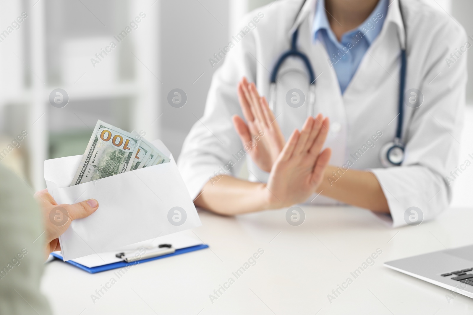 Photo of Doctor rejecting bribe in clinic, closeup. Corrupted medicine