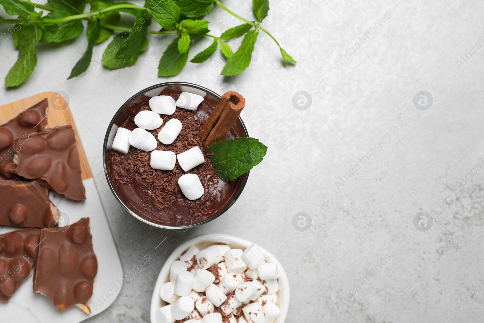 Photo of Flat lay composition with cup of delicious hot chocolate on light grey table, space for text