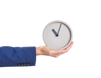 Photo of Young businesswoman holding clock on white background. Time management