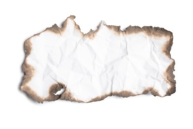 Photo of Piece of crumpled paper with dark burnt borders on white background, top view. Space for text