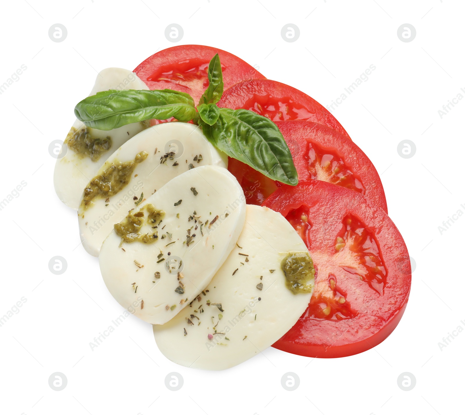 Photo of Tasty salad Caprese with mozzarella, tomatoes, basil and pesto sauce isolated on white