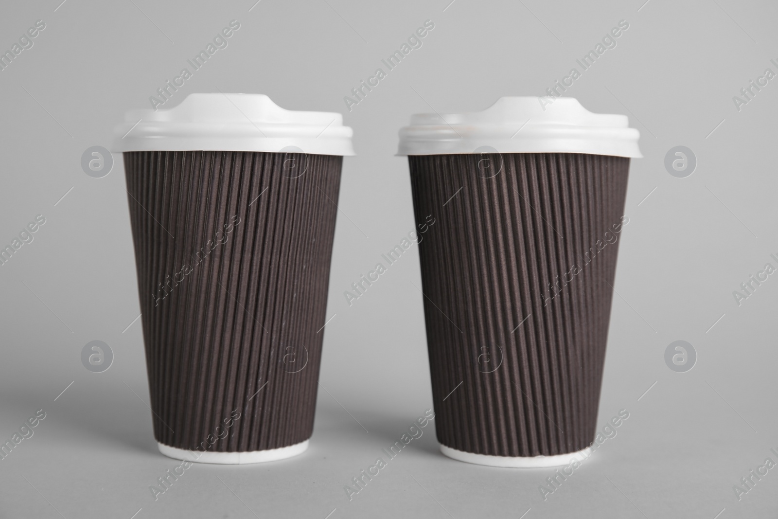 Photo of Carton cups on grey background. Mock up for design