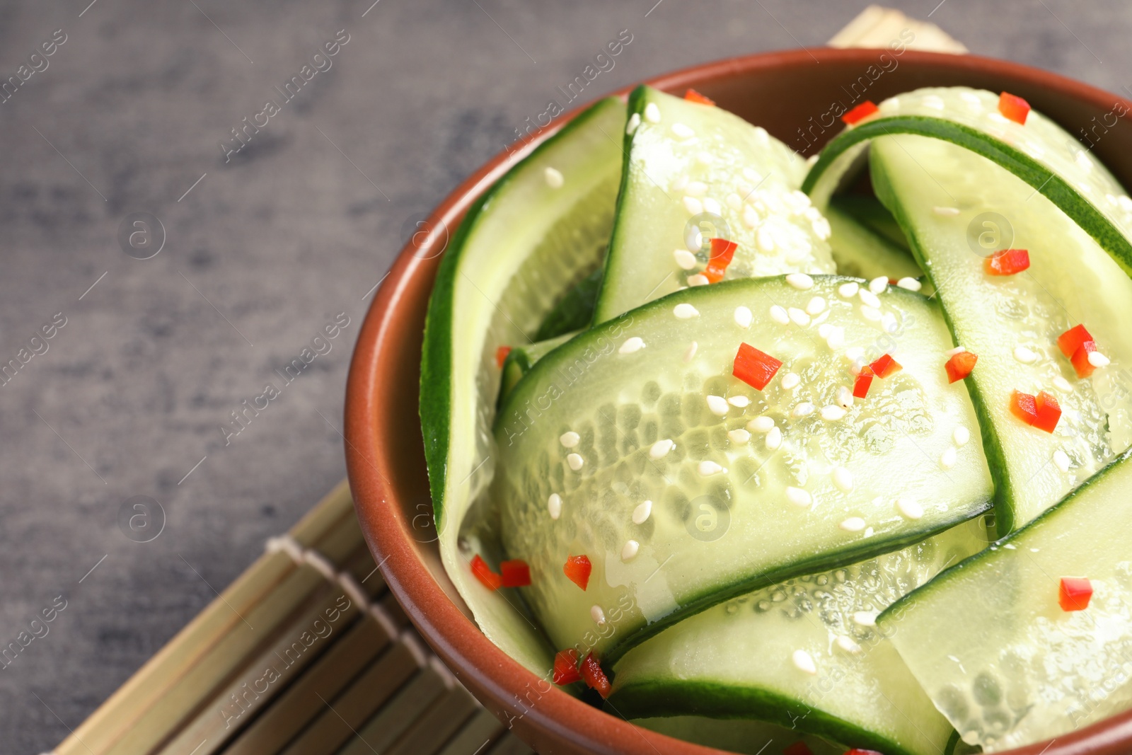 Photo of Dish with fresh cucumber salad on table, closeup