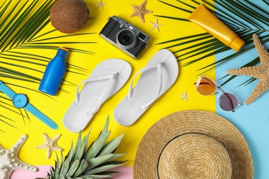 Photo of Flat lay composition with beach accessories on colorful background