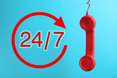 Image of 24/7 hotline service. Red handset on blue background